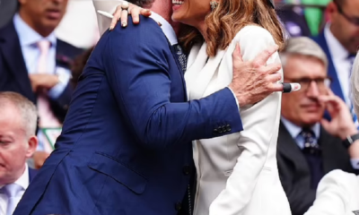 Former co-stars Hugh Jackman and Kate Beckinsale cuddle and whisper into each other's ears as they are reunited at Wimbledon