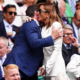 Former co-stars Hugh Jackman and Kate Beckinsale cuddle and whisper into each other's ears as they are reunited at Wimbledon