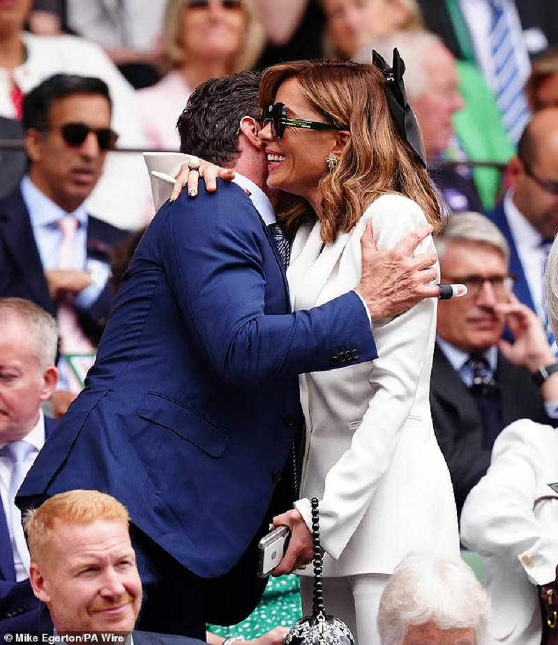 Former co-stars Hugh Jackman and Kate Beckinsale cuddle and whisper into each other's ears as they are reunited at Wimbledon